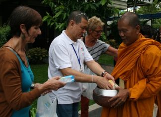 Foreign volunteers make merit on Father Ray Day.